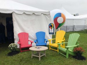 4 brightly coloured adirondack chairs in a semi-circle