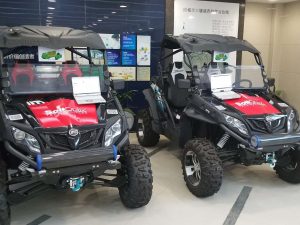 Two field vehicles parked side by side in showroom