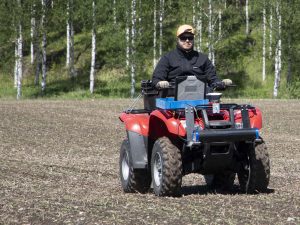 Quad with operator driving through field