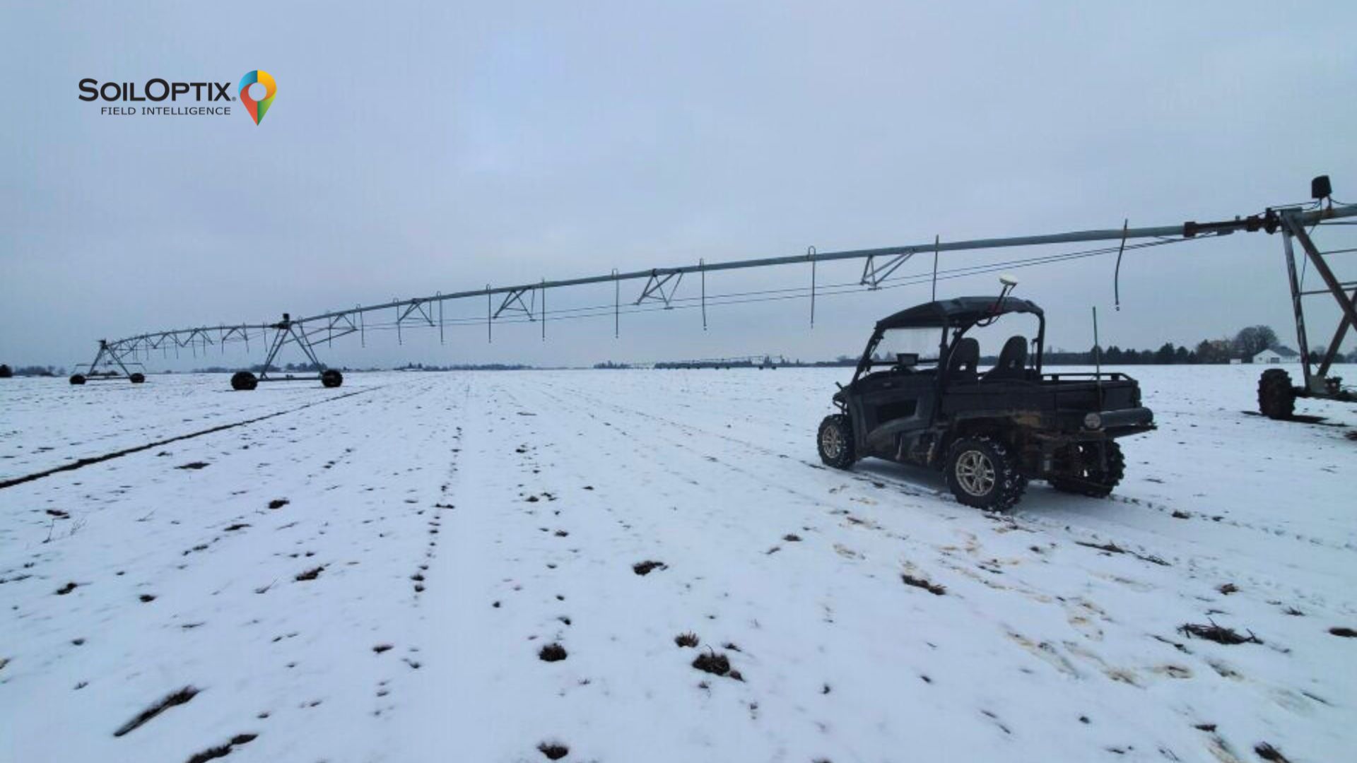 A SoilOptix® field vehicle parked beside a center-pivot irrigation system during winter soil surveying on a snow-covered agricultural field, highlighting winter soil management and early spring preparation.